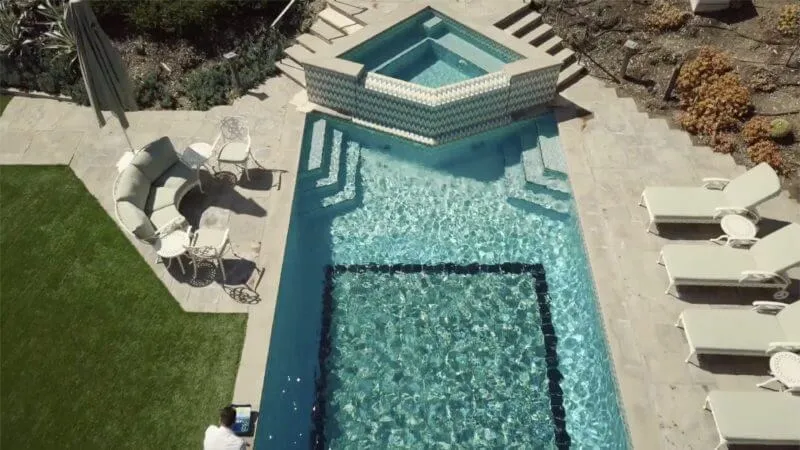Aerial view of a sparkling backyard pool and spa